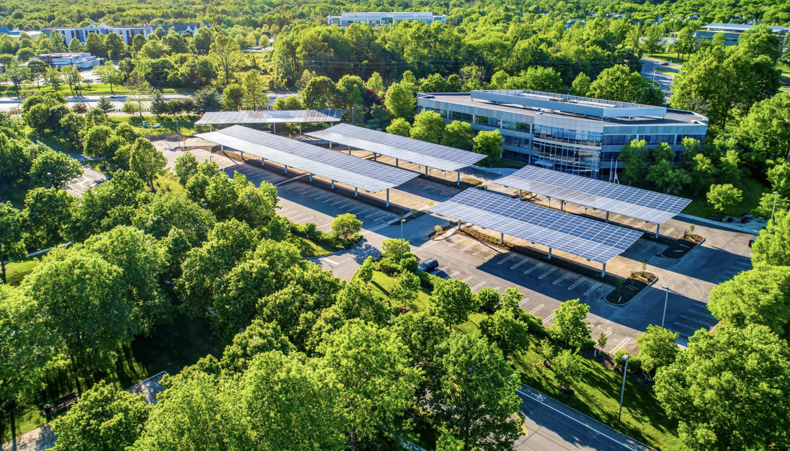 Overhead view of an office building and solar canopy arrays.