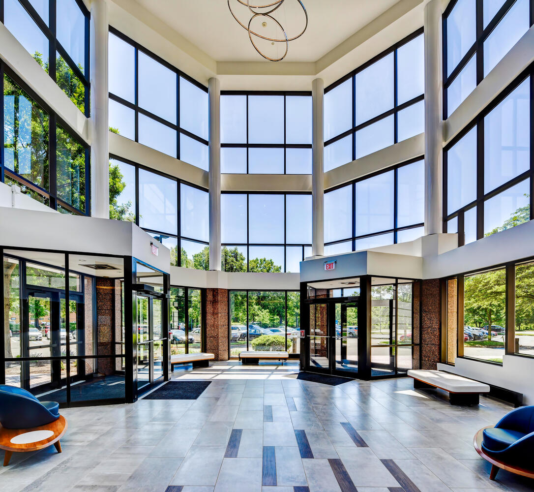 Interior shot of office building lobby featuring full glass entrance.