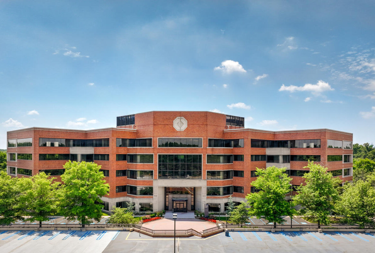 Exterior shot of a 5-story brick office building.