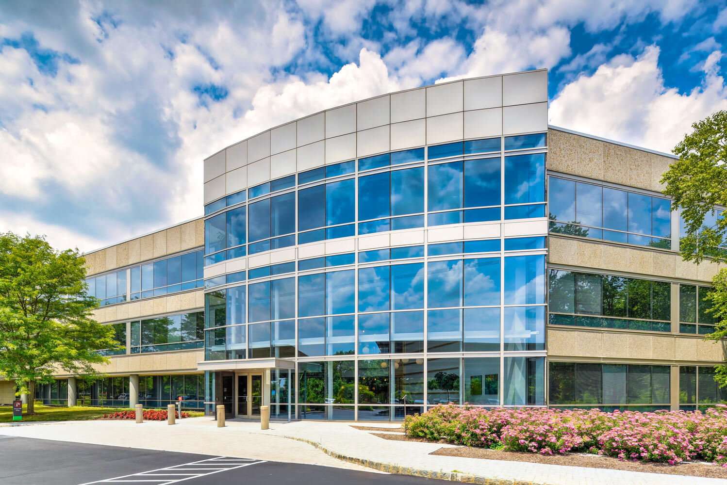 Exterior shot of a glass building at a side angle.